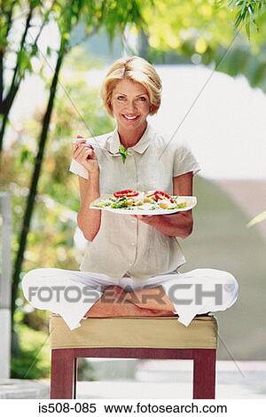 Woman eating outdoors View Large Photo Image Stock Photography - Woman eating outdoors. Fotosearch