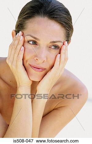 Stock Photo - Woman holding face in hands. Fotosearch