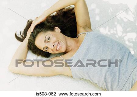 Woman lying down outdoors View Large Photo Image Stock Image - Woman lying down outdoors. Fotosearch