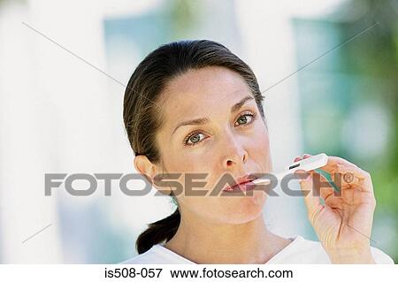 Stock Photo - Woman taking her temperature. Fotosearch