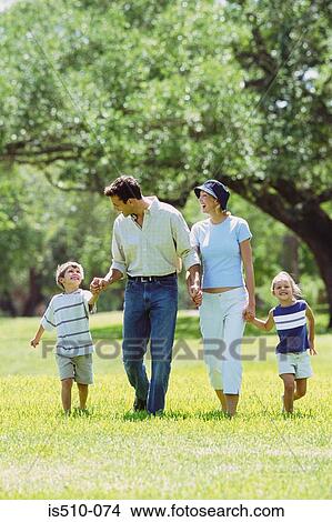 Picture - Family walking in the park. Fotosearch
