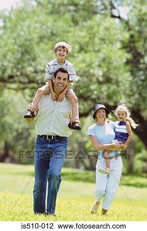 Stock Image - Family walking in the park. Fotosearch