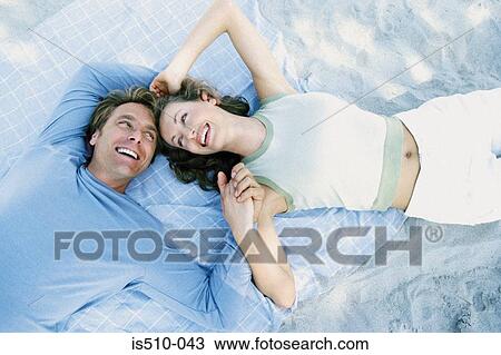 Stock Image - Man and woman lying down together. Fotosearch