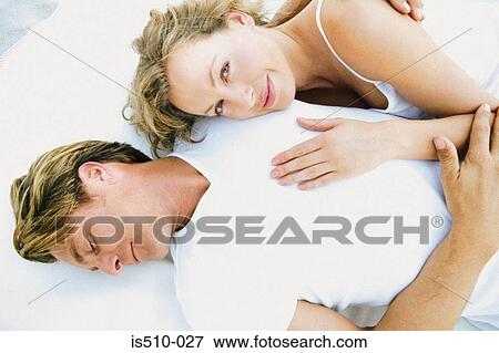Stock Photo - Man and woman lying down together. Fotosearch