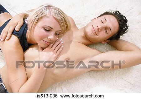 Stock Photograph - Young couple cuddling. Fotosearch