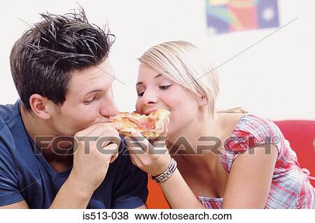 Stock Photo - Young couple eating together. Fotosearch