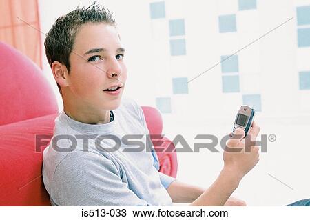Young man using cellphone View Large Photo Image Stock Image - Young man using cellphone. Fotosearch