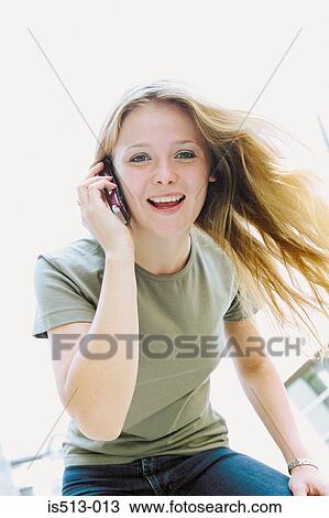 Young woman on cellphone View Large Photo Image Stock Image - Young woman on cellphone. Fotosearch