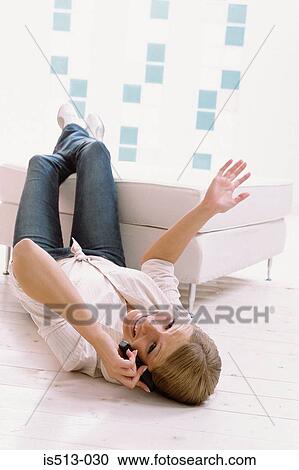 Stock Image - Young woman on cellphone. Fotosearch