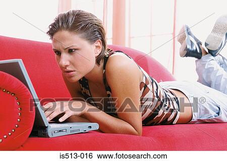 Stock Photograph - Young woman on laptop computer. Fotosearch