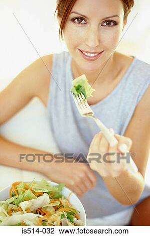 Stock Image - Woman eating. Fotosearch