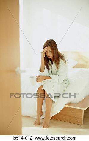 Stock Image - Woman holding her head. Fotosearch