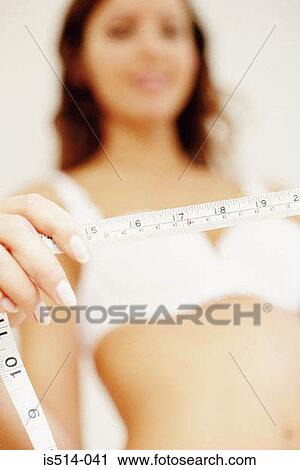 Stock Image - Woman measuring herself. Fotosearch
