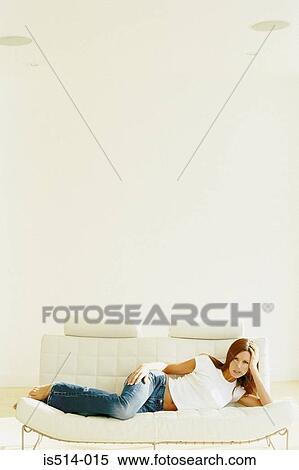 Stock Photography - Woman relaxing on sofa. Fotosearch