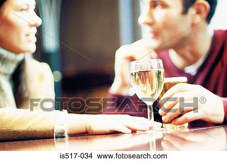 Couple having a drink View Large Photo Image Picture - Couple having a drink. Fotosearch