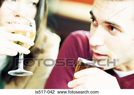 Couple having a drink View Large Photo Image Stock Image - Couple having a drink. Fotosearch