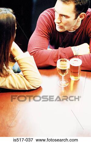 Couple having a drink View Large Photo Image Stock Photo - Couple having a drink. Fotosearch