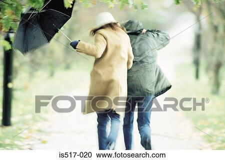 Couple under umbrella View Large Photo Image Stock Image - Couple under umbrella. Fotosearch