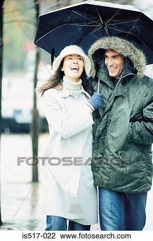 Couple under umbrella View Large Photo Image Stock Image - Couple under umbrella. Fotosearch