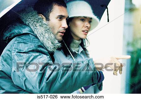 Couple under umbrella View Large Photo Image Stock Photograph - Couple under umbrella. Fotosearch