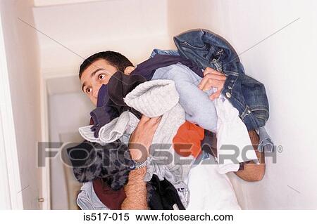 Stock Photography - Man with dirty laundry. Fotosearch