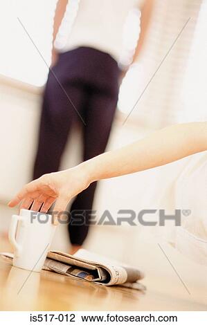 Stock Image - Reaching for cup of tea. Fotosearch