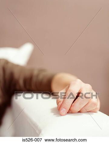 A male hand on the sofa arm View Large Photo Image Stock Photo - A male hand on the sofa arm. Fotosearch