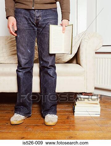 A young man reading a book View Large Photo Image Stock Photo - A young man reading a book. Fotosearch