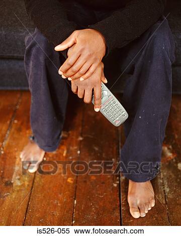 Man holding a remote control for digital TV View Large Photo Image Stock Photography - Man holding a remote control for digital TV . Fotosearch