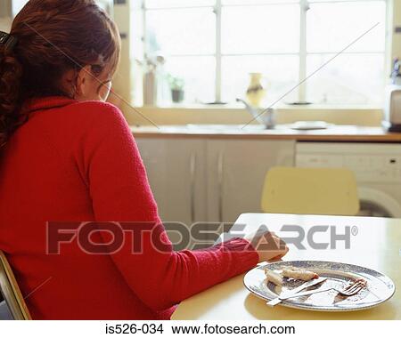 Picture - Woman at the dining-table . Fotosearch