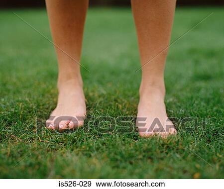 Woman on grass with bare feet View Large Photo Image Stock Photo - Woman on grass with bare feet. Fotosearch