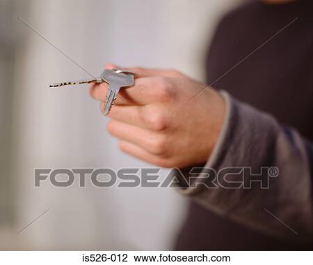 Young man holding keys View Large Photo Image Stock Image - Young man holding keys . Fotosearch