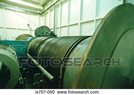 Stock Image - Winding drum with coiled cable in engine room of a moderncontainer crane. Fotosearch