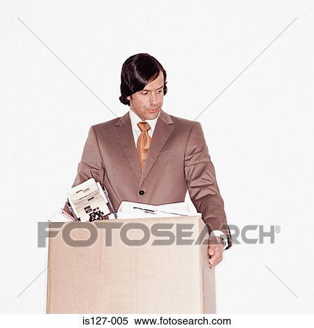 Stock Photography - Businessman carrying a box of papers. Fotosearch