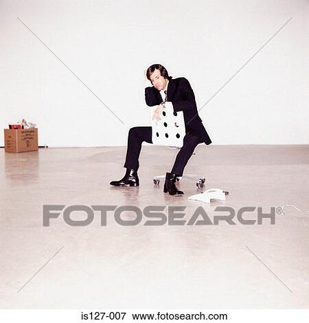 Stock Photo - Businessman sitting on a chair. Fotosearch