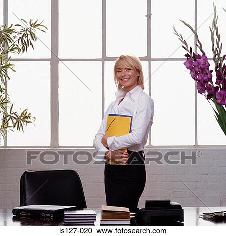 Businesswoman holding folders View Large Photo Image Stock Image - Businesswoman holding folders. Fotosearch