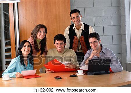 Businesspeople at desk View Large Photo Image Stock Image - Businesspeople at desk. Fotosearch
