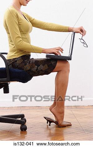 Stock Image - Businesswoman using laptop. Fotosearch