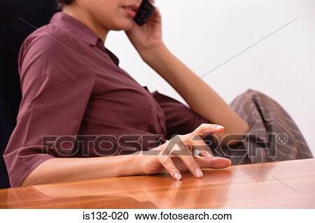 Stock Image - Businesswomen using cell phone. Fotosearch
