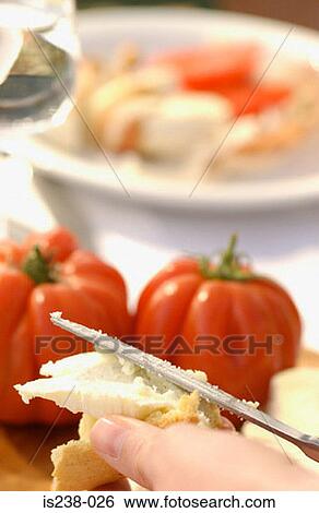Stock Photograph - Hand holding bread and cheese. Fotosearch