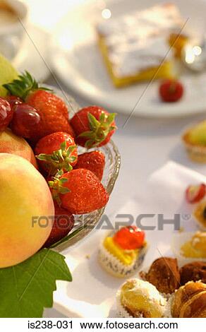 Stock Image - Strawberries and cakes. Fotosearch