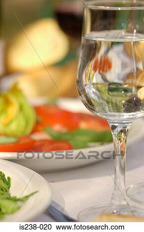 Wine glass by plate of tomatoes View Large Photo Image Stock Image - Wine glass by plate of tomatoes. Fotosearch