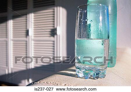 Stock Photo - Bottle and glass of water. Fotosearch