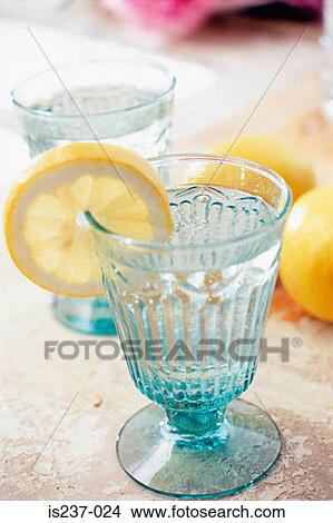 Slice of lemon with glass of water View Large Photo Image Picture - Slice of lemon with glass of water. Fotosearch