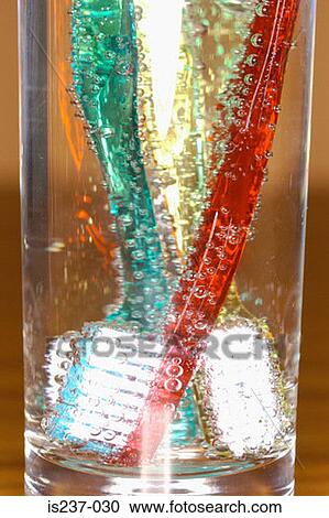Stock Image - Toothbrushes in drinking glass. Fotosearch