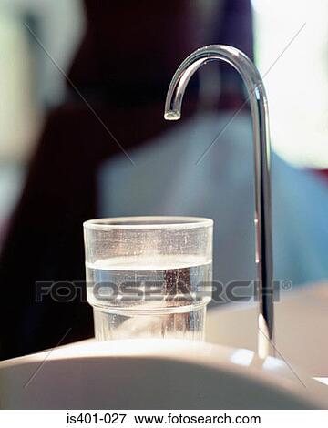 Faucet and water in glass View Large Photo Image Stock Photo - Faucet and water in glass. Fotosearch