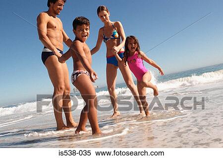 A family on a beach View Large Photo Image Stock Photography - A family on a beach. Fotosearch