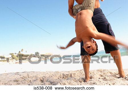 Boy playing on the beach View Large Photo Image Stock Photo - Boy playing on the beach. Fotosearch