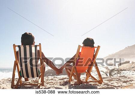 Children holding hands on a beach View Large Photo Image Stock Photo - Children holding hands on a beach. Fotosearch