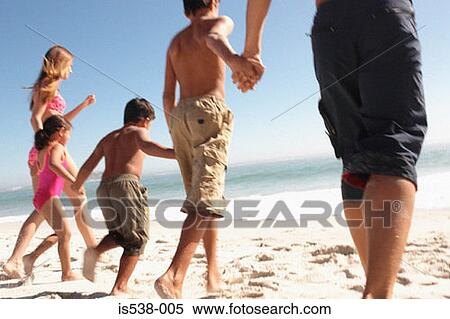 Family holding hands on a beach View Large Photo Image Stock Photography - Family holding hands on a beach. Fotosearch